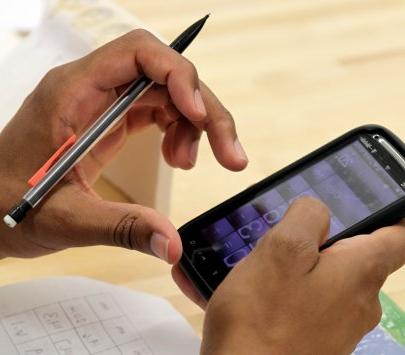 Employee with calculator app and pencil