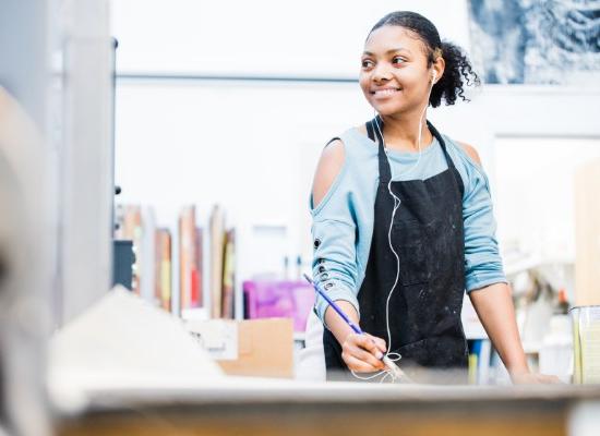 Art student holding a paintbrush.